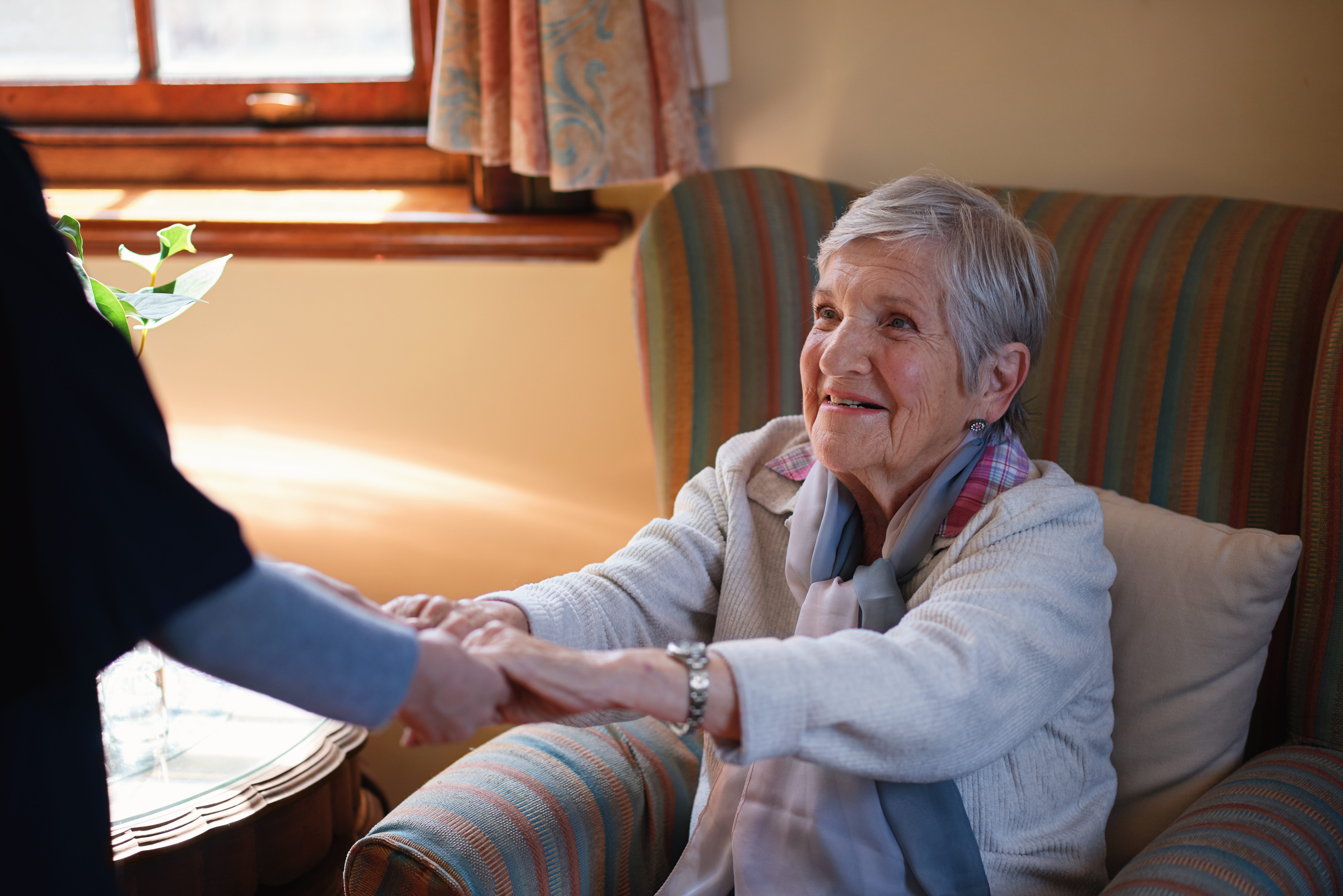Nurse,Helping,Old,Woman,Holding,Hands,In,Retirement,Home
